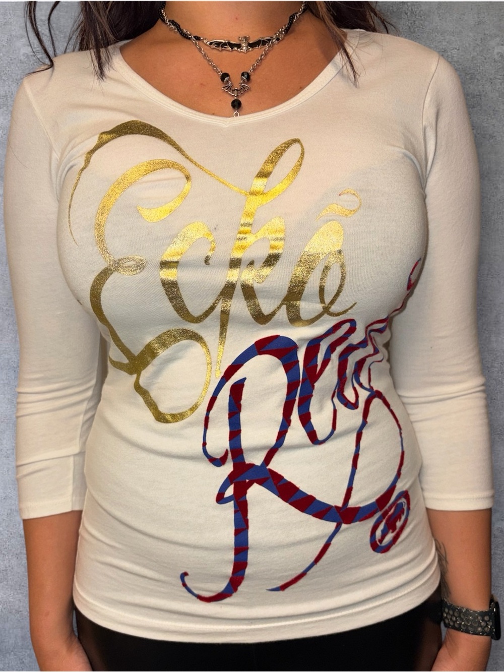 Ecko Unlimited White Long Sleeve Top with Gold Script and Red-Blue Graphic